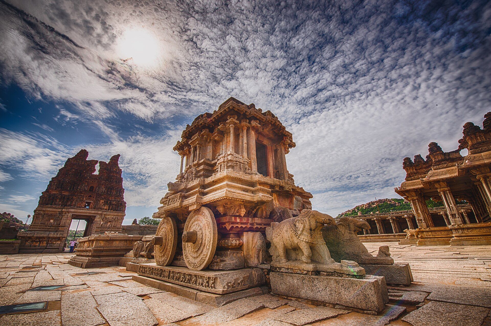 The stone chariot at Hampi's Vittala Temple under a wide, cloud-streaked sky