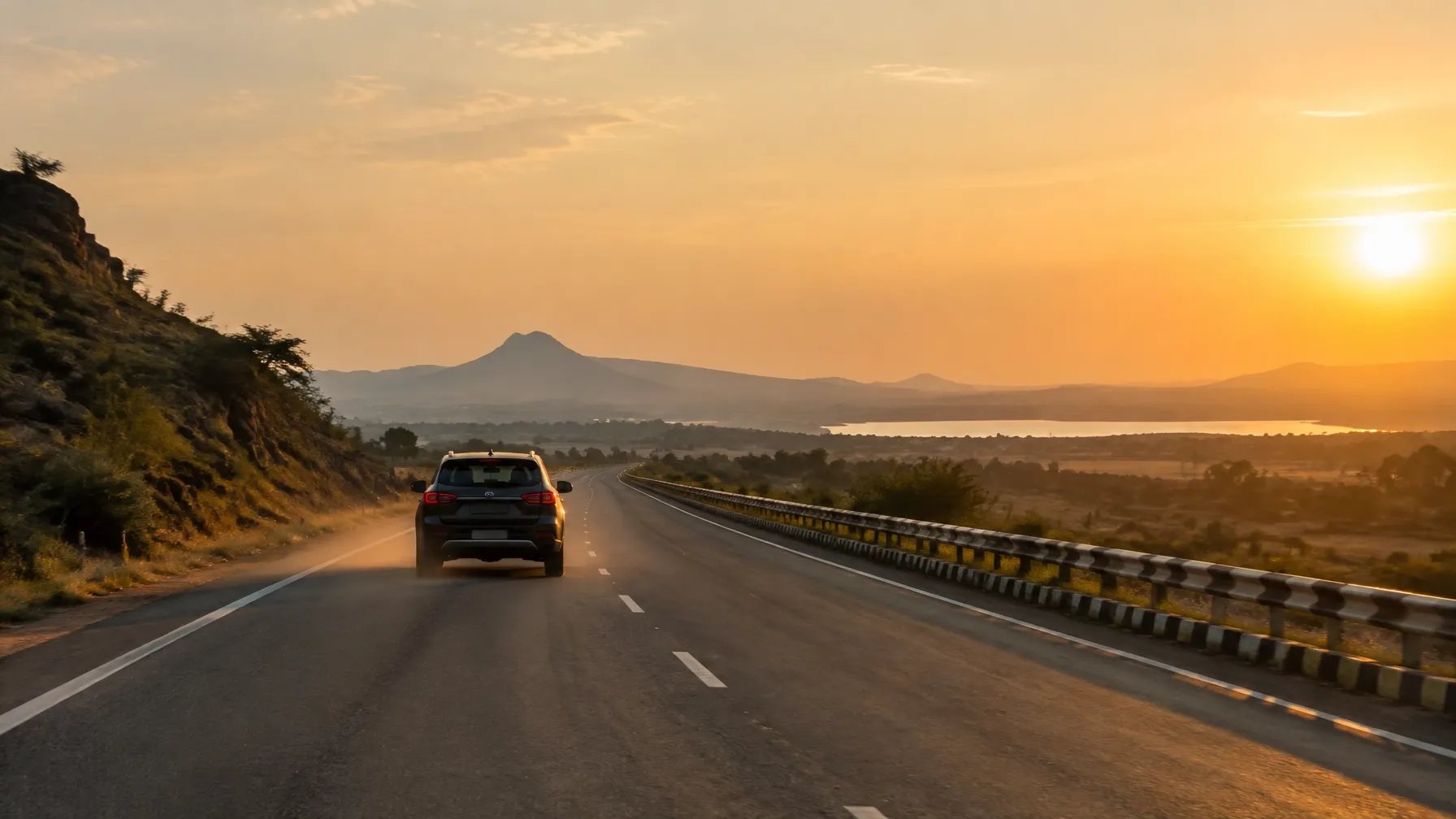 A road-trip car travelling through the Indian hills at golden hour